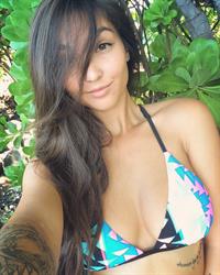 Kristina Chai in a bikini taking a selfie