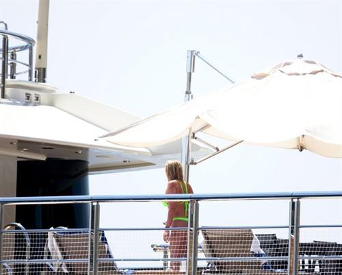 Stassie Karanikolaou Bikini Pictures Stassie Karanikolaou sexy ass in a green thong bikini showing nice cleavage with her big boobs seen by paparazzi.