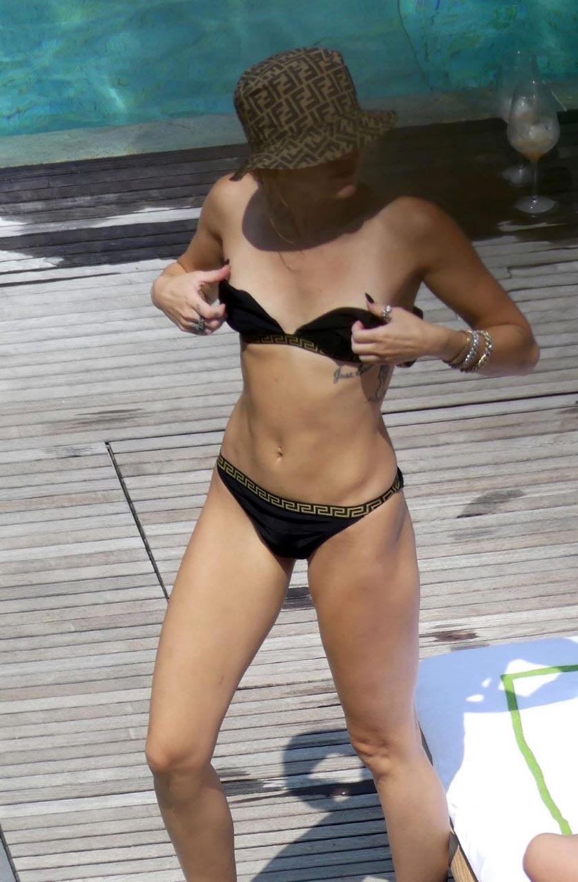 Miley Cyrus Bikini Pictures Miley Cyrus and Kaitlynn Carter making out kissing by the pool seen by paparazzi showing her lesbian side after leaving Liam Hemsworth.