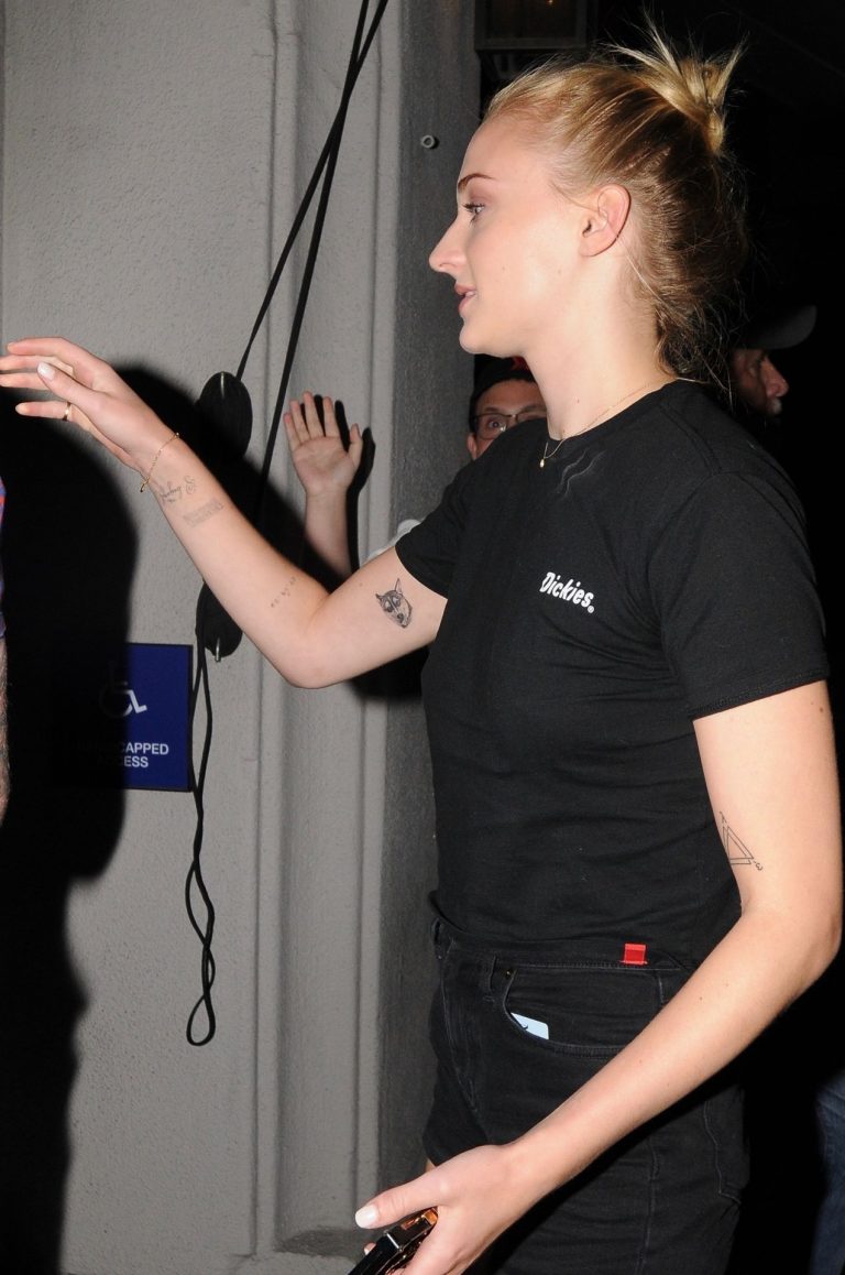Sophie Turner (Actress) Pictures Sophie Turner braless boobs in a black shirt seen by paparazzi showing her tits and her pierced nipple.