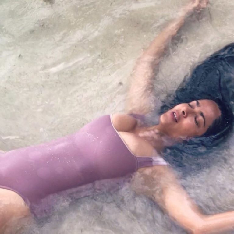 Salma Hayek Pictures Salma Hayek big boobs showing nice cleavage wet in a swimsuit laying on the beach.