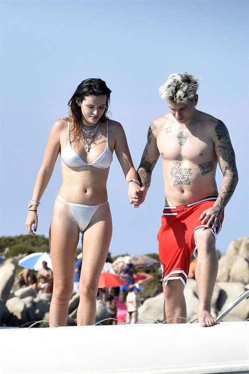 Bella Thorne Bikini Pictures Bella Thorne sexy in a thong bikini drinking and smoking weed out on the water showing off her ass seen by paparazzi.