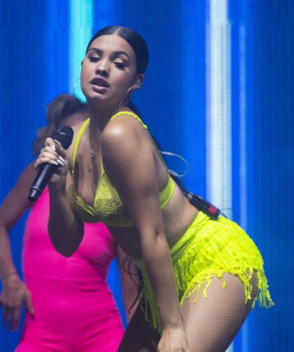 Mabel performing on stage singing in just a bra top showing off her boobs.
















