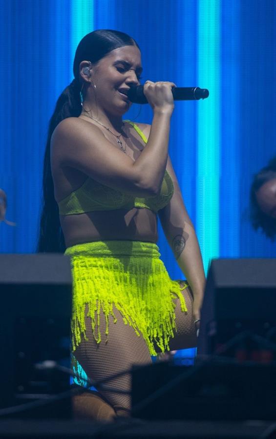 Mabel performing on stage singing in just a bra top showing off her boobs.
















