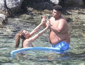 Katie Price caught nude with her son by paparazzi showing her topless boobs.

