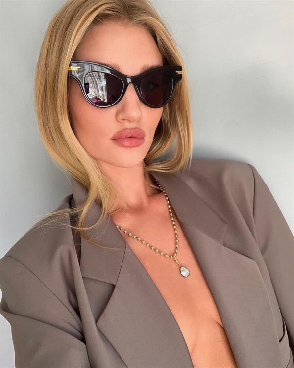 Rosie Huntington-Whiteley braless nude boobs in just an open jacket.

