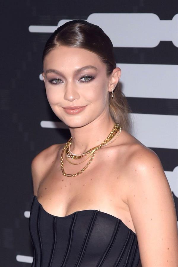Gigi Hadid braless boobs in a see through top showing off her tits seen by paparazzi with Cara Delevingne and Joan Smalls.














































