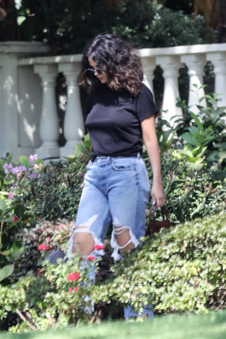 Selena Gomez Pictures Selena Gomez braless boobs in a black top seen by paparazzi.