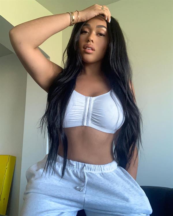 Jordyn Woods tits in a tight white little top showing off her big boobs and hard nipples.
