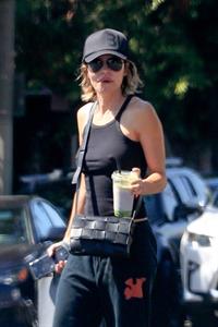 Lisa Rinna Pictures Lisa Rinna braless tits pokies in a black top showing off her boobs seen by paparazzi.