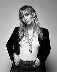 Miley Cyrus braless tits in a white top showing off her boobs.










































































