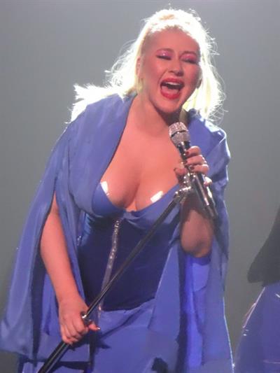 Christina Aguilera wardrobe malfunction with her big braless boobs on stage accidentally flashing the tape on her tits.
















