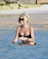 Victoria Silvstedt sexy ass in a black bikini showing nice cleavage with her big boobs seen by paparazzi on the beach and in the water in St Barths.