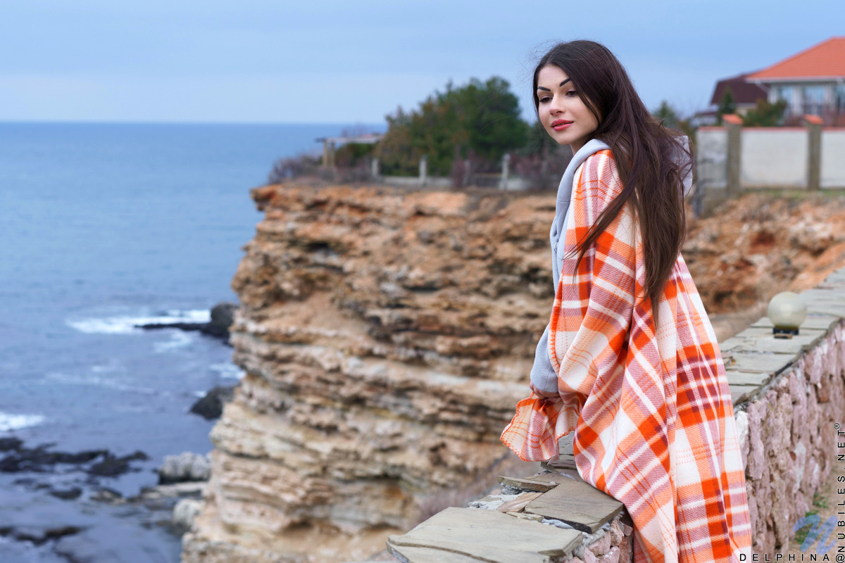 Long chestnut hair waves in the wind before Delphina comes inside. Relocating to the bedroom, she peels off her panties and slides her fingers down her slippery twat. She's already wet and ready to cum, so watch her slide her fingers into her cream filled fuck hole as she moans in pure delight.