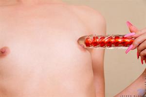 Stunning in a red dress, Jayden Black awaits you for a Valentine's date. She even warms herself up nicely for a good time, peeling off her dress and panties so she can use a glass dildo to tease her nipples to hard peaks and to rock her dripping bald fuck hole's world.