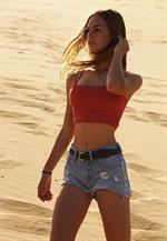 Emily Feld Pictures Emily Feld in Daisy Duke Jean Shorts and a Red Halter Top