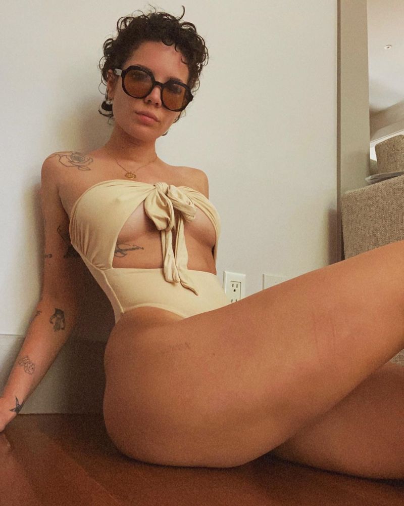 Halsey boobs showing nice underboob cleavage with her big tits pokies in a  sexy swimsuit sitting at home on the floor 8.38/10