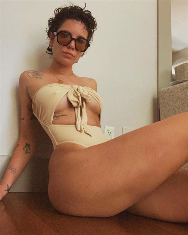 Halsey boobs showing nice underboob cleavage with her big tits pokies in a sexy swimsuit sitting at home on the floor.