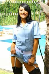  Penelope the dark haired beauty in a nurse uniform with sexy white lingerie and black stockings. 