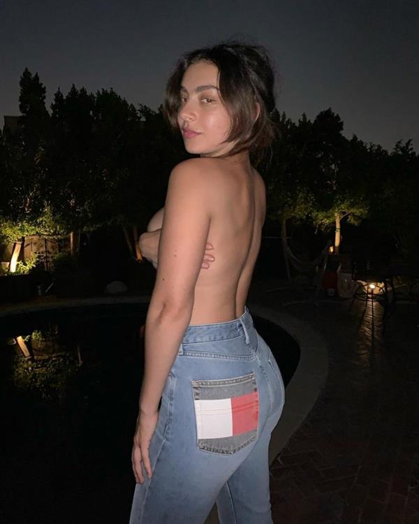 Charli XCX nude boobs new photo taken outside next to her pool wearing just jeans while holding her topless big tits.