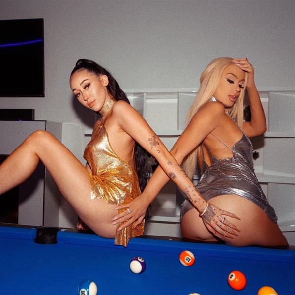 Noah Cyrus and Tana Mongeau grabbing each others asses while both going braless in sexy little dressses and matching thongs.