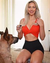 Paige Spiranac braless boobs showing nice cleavage with her big tits in a sexy little orange top.
