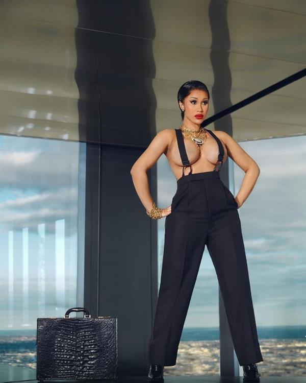 Cardi B topless boobs new pic from a photoshoot posing with suspenders barely covering her nude big tits.