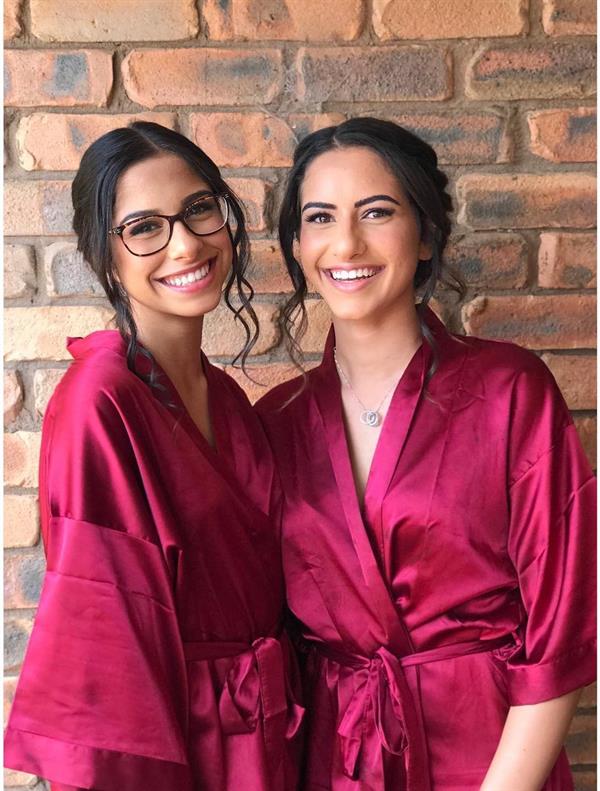 Alex (left) with her big sister Georgia (right), both looking gorgeous in pink robes.