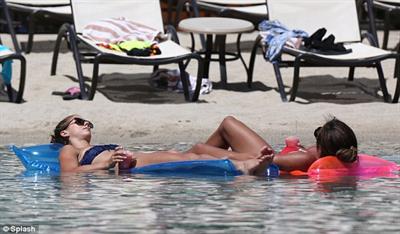 Alex Morgan and Sydney Leroux in bikinis on the beach in Hawaii